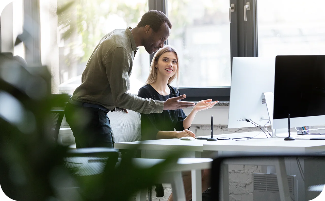 Team members collaborating at a computer