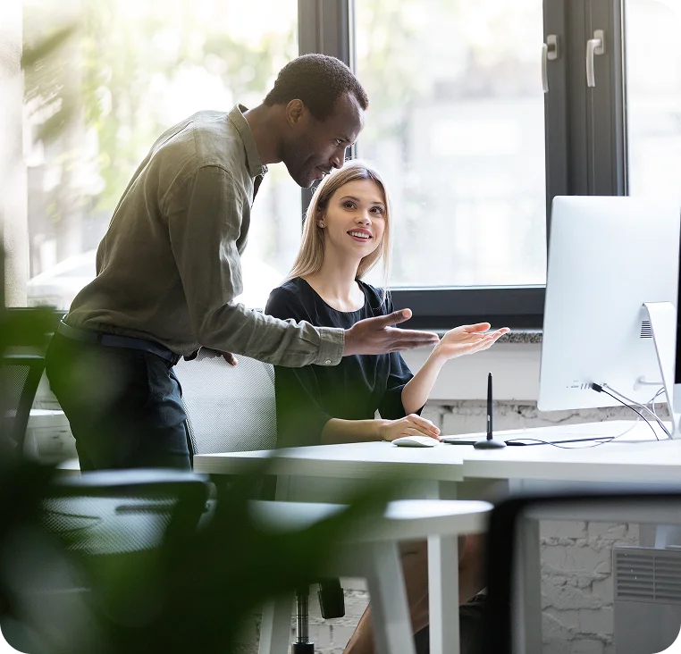 Team members collaborating at a computer